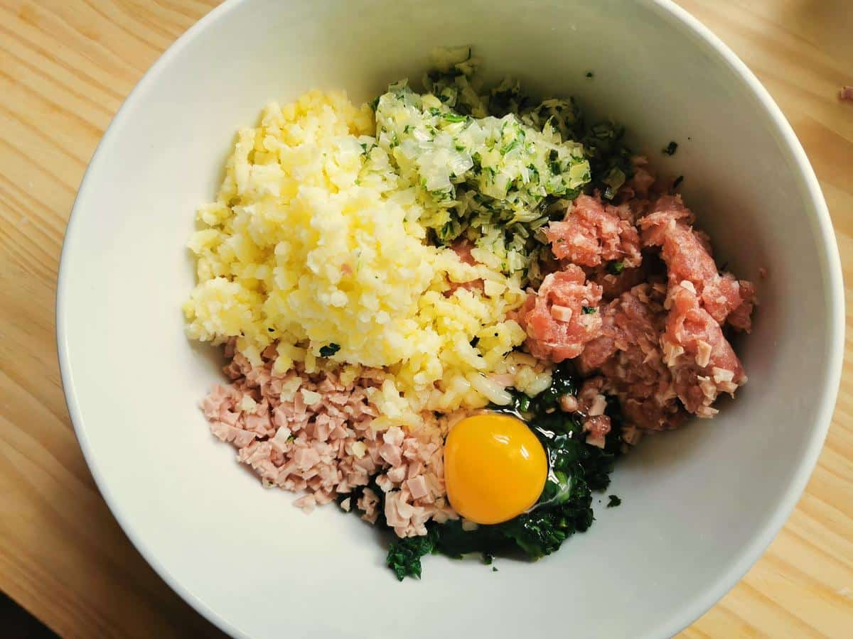 Casoncelli (casonsei) filling ingredients in white bowl.