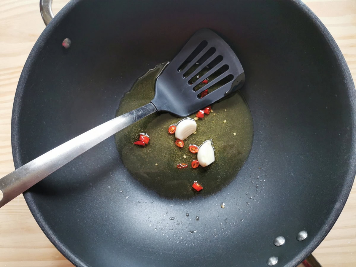 Garlic and chili cooking in a pan with olive oil.