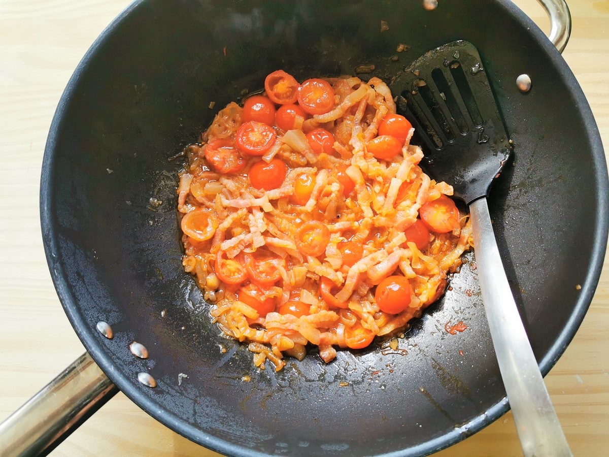 Ready shallot and guanciale sauce in deep frying pan.