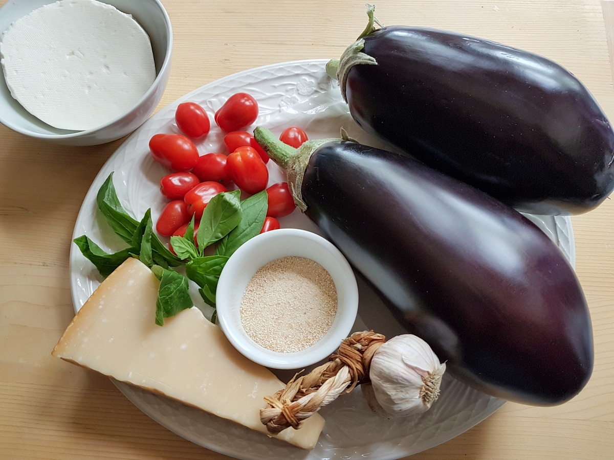 Eggplant boat ingredients on a kitchen table.