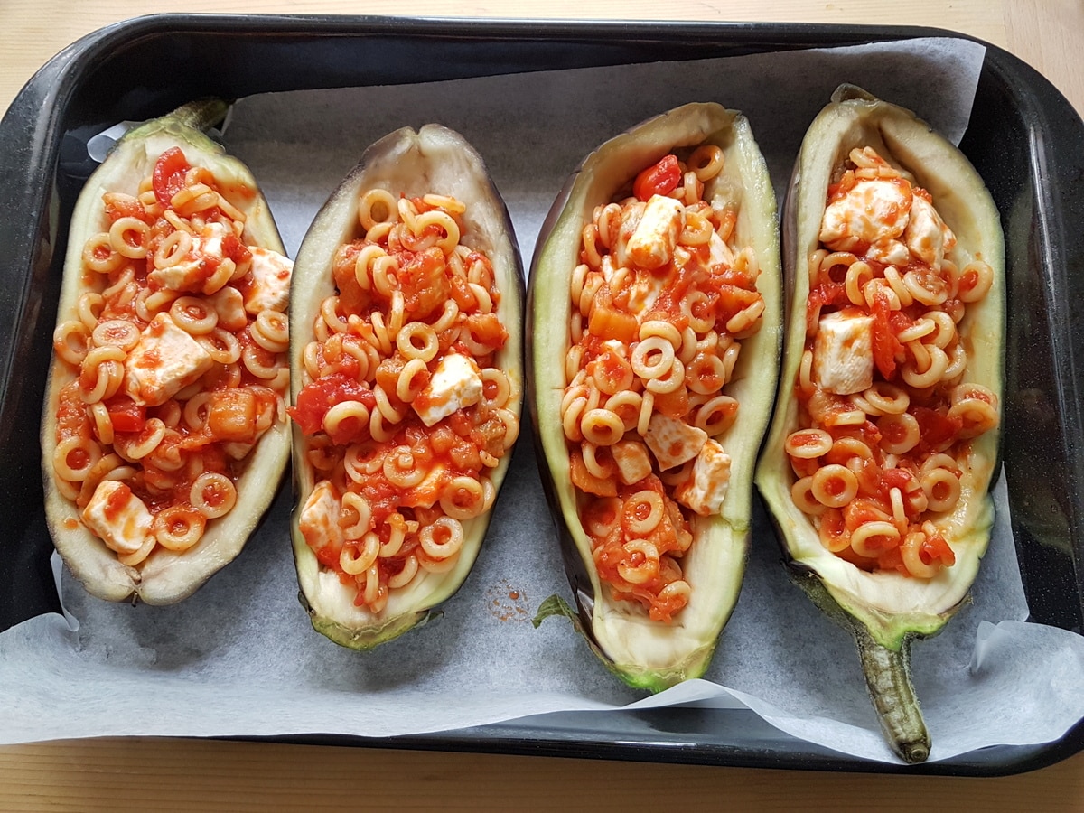 Eggplant boats stuffed with tomato and pasta.