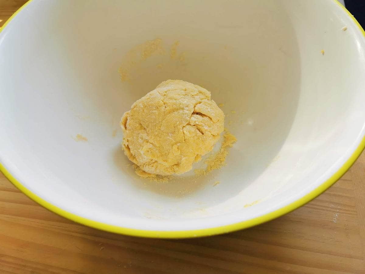 Rough ball of tagliatelle dough in large bowl.