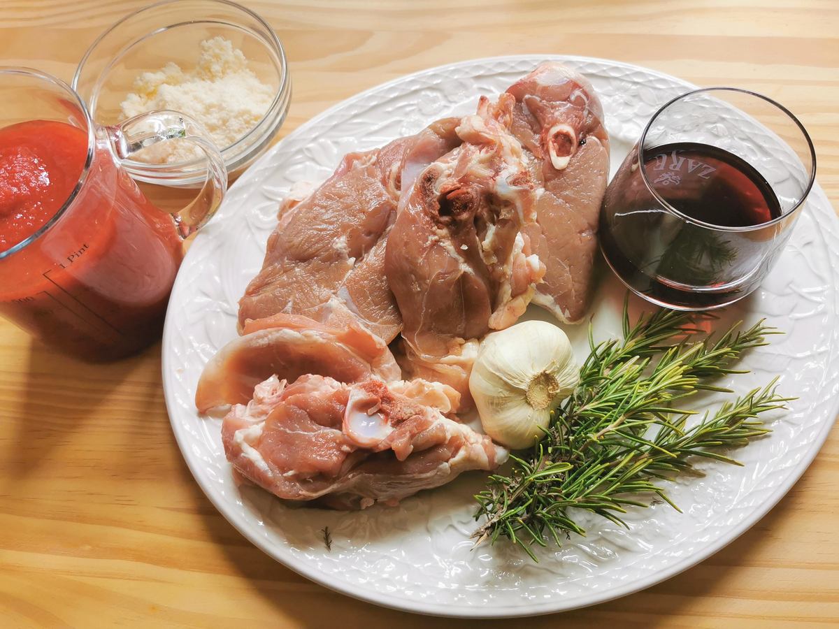 Ingredients for lamb ragu on a kitchen table.