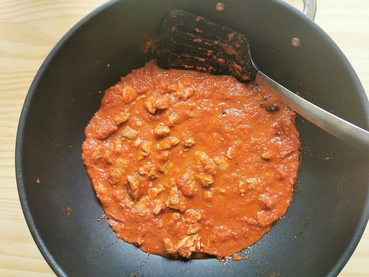 Lamb ragu simmered in a pan.