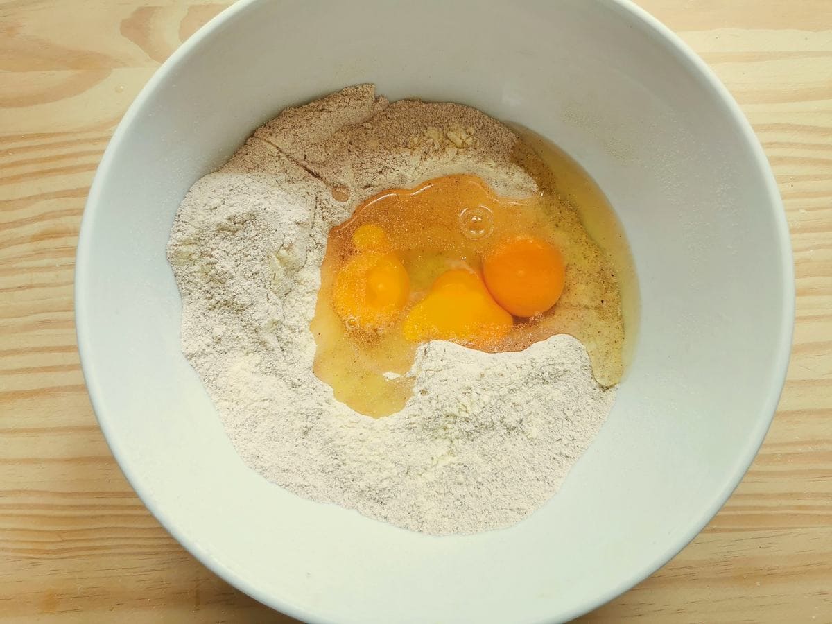 Chestnut and semolina fours in white bowl with eggs, salt and olive oil.