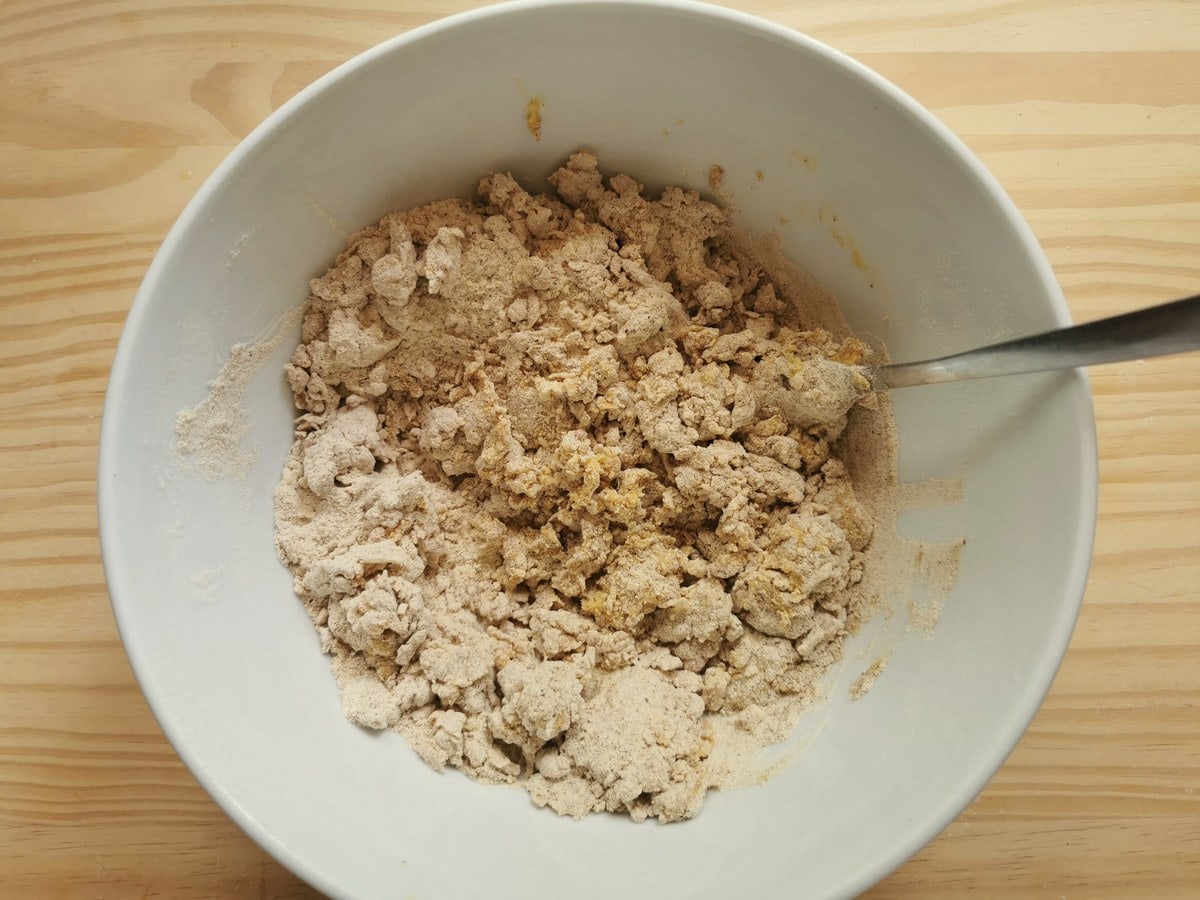 Chestnut and semolina flour in white bowl mixed with eggs, salt and olive oil.