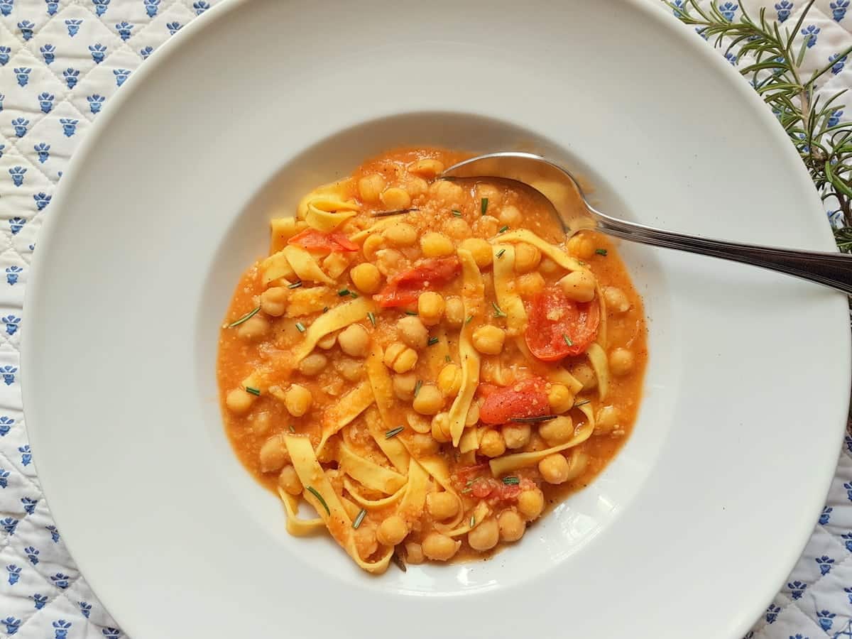 Vegan tagliatelle with chickpea soup in bowl.