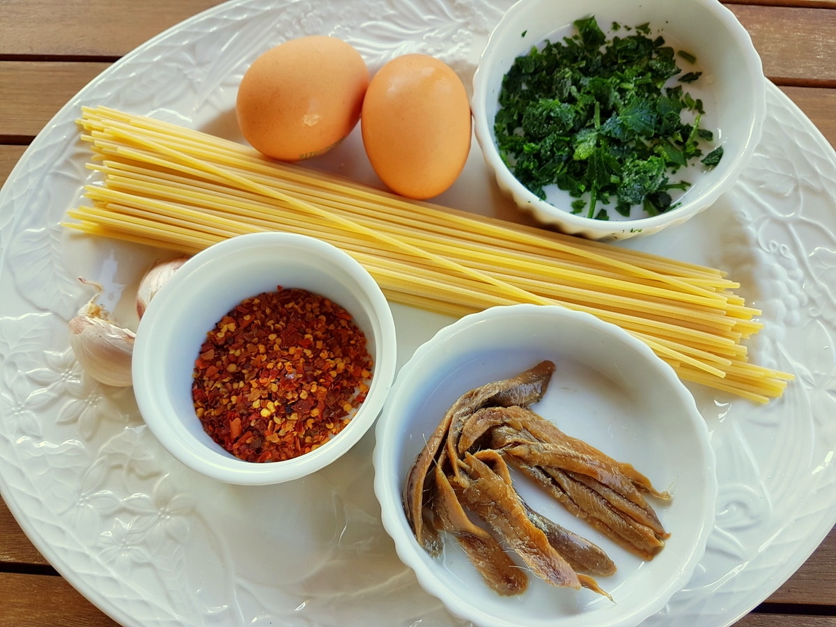 Pasta frittata portioned and on a wooden table.