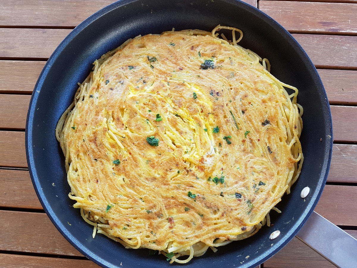 Pasta frittata that has a slightly brown and crispy top.