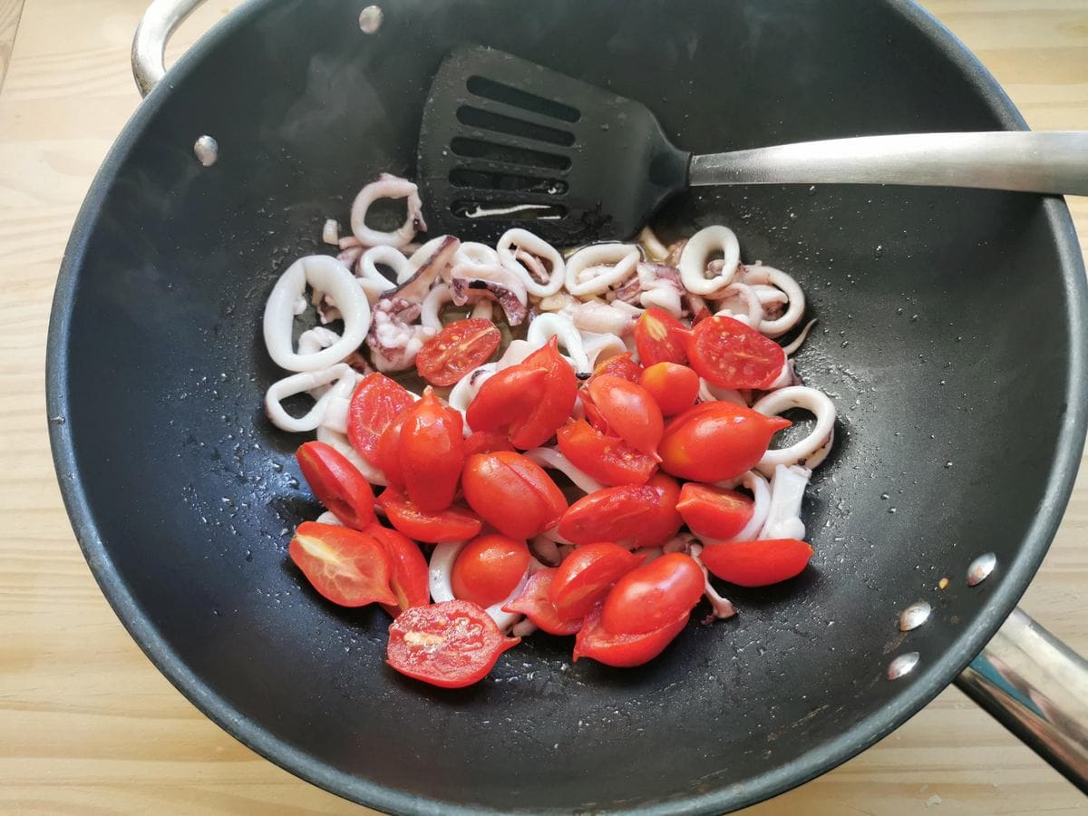 Cherry tomatoes added to the pan.