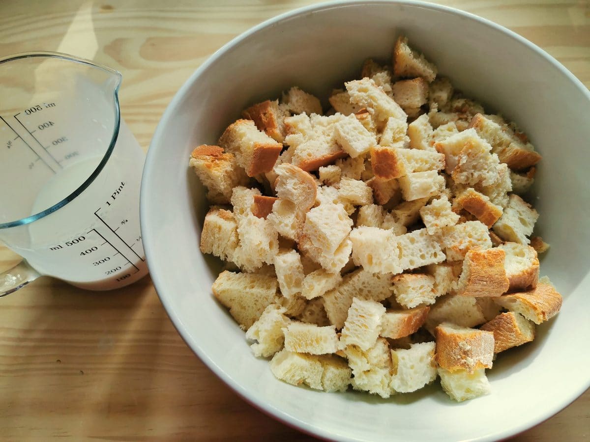 A bowl of stale bread cubes with milk.