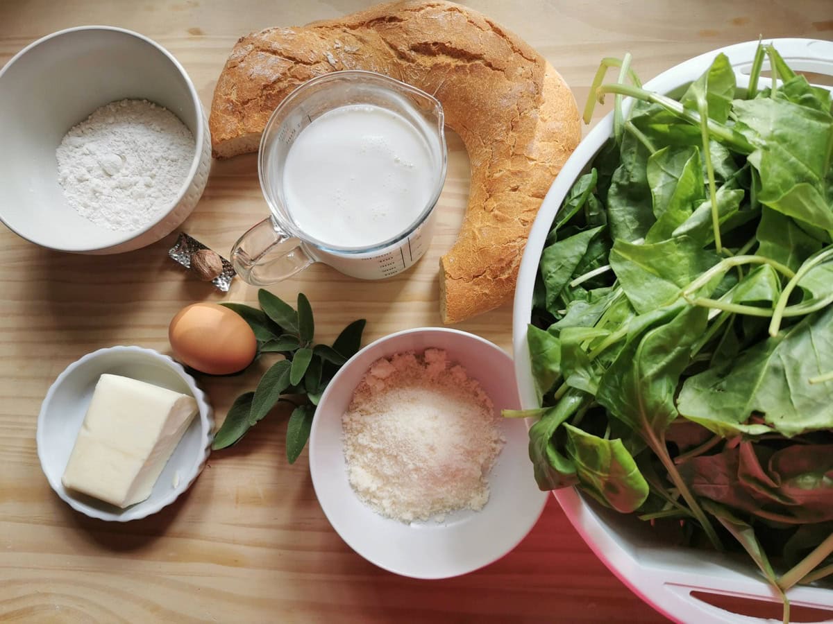 Ingredients for strangolapreti gnocchi on wood work surface.